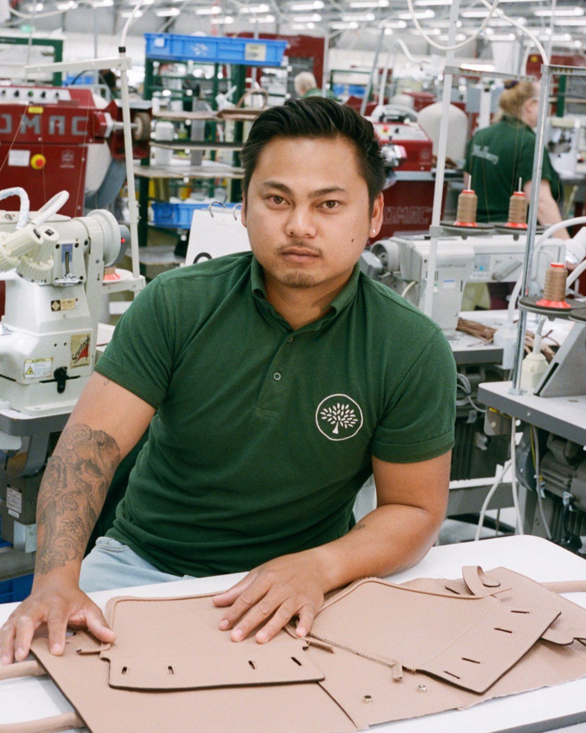 Mulberry employee in the Somerset factory stitching and inking